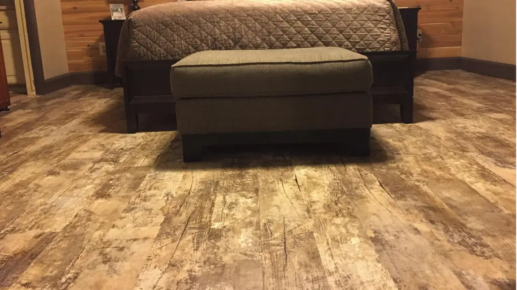 Reclaimed-look luxury vinyl plank running through a finished bedroom